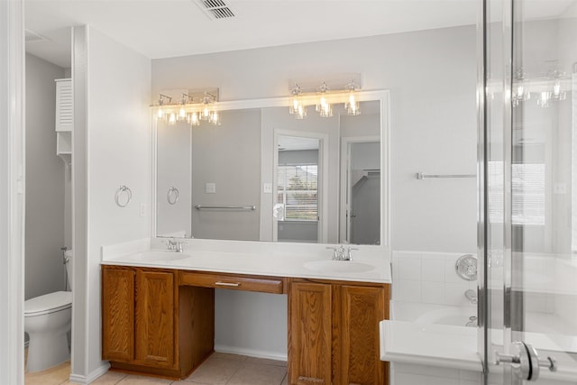 bathroom featuring a sink, tile patterned floors, double vanity, and visible vents