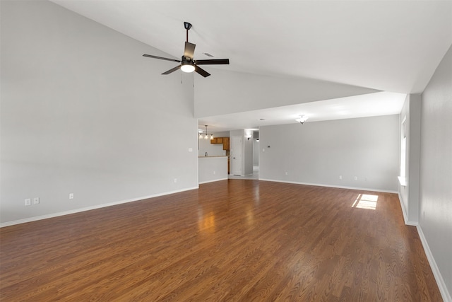 unfurnished living room with wood finished floors, ceiling fan with notable chandelier, baseboards, and high vaulted ceiling