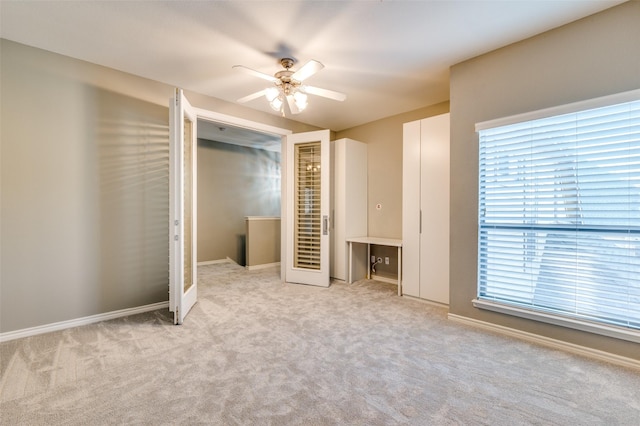 unfurnished bedroom with baseboards, carpet floors, and ceiling fan