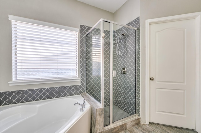 full bath featuring a garden tub and a stall shower