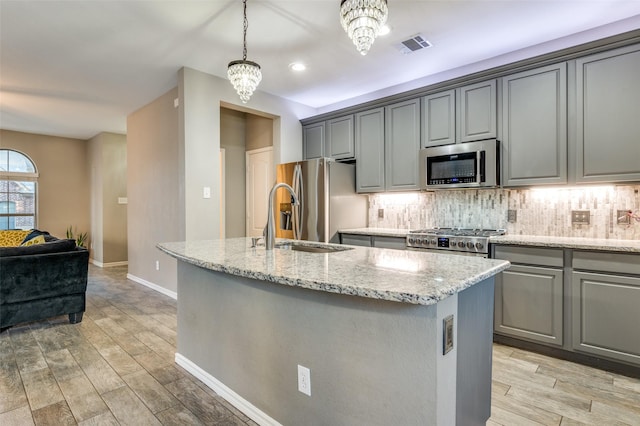 kitchen featuring visible vents, appliances with stainless steel finishes, gray cabinetry, and decorative backsplash