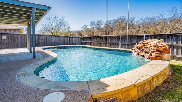 view of swimming pool featuring a fenced in pool, a patio, and a fenced backyard