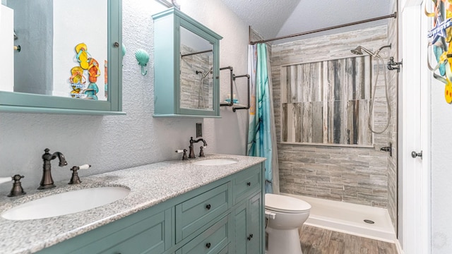 bathroom featuring a sink, a textured ceiling, and a shower stall