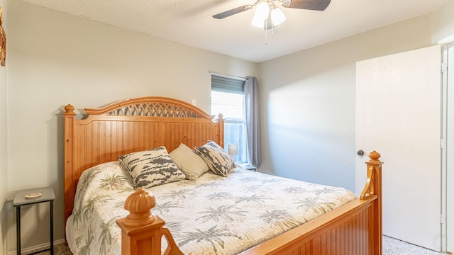 bedroom with a textured ceiling, carpet flooring, and ceiling fan