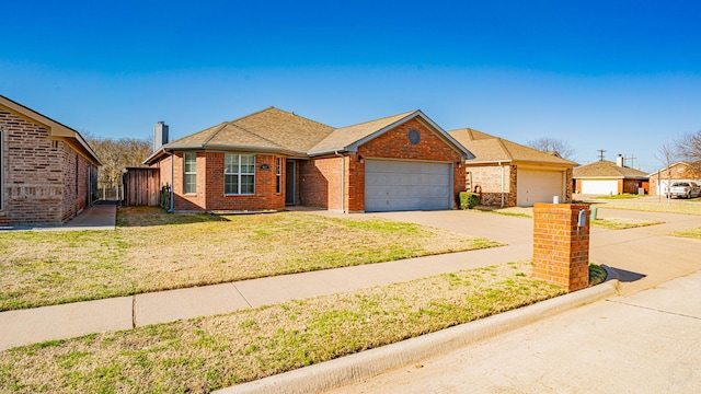 view of front of home with brick siding, fence, concrete driveway, a front yard, and a garage