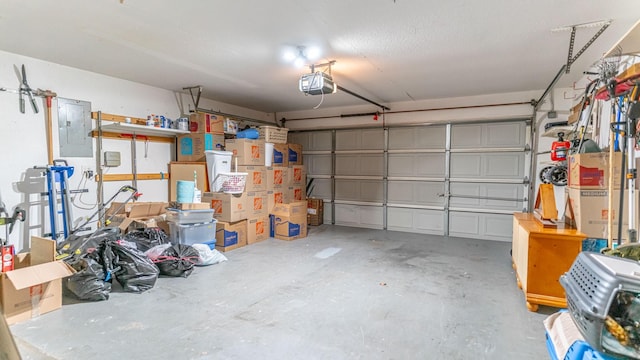 garage with electric panel and a garage door opener