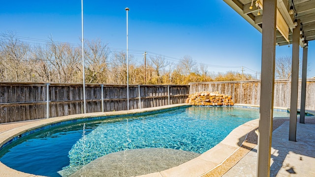 view of swimming pool with a fenced in pool, a fenced backyard, and a patio area