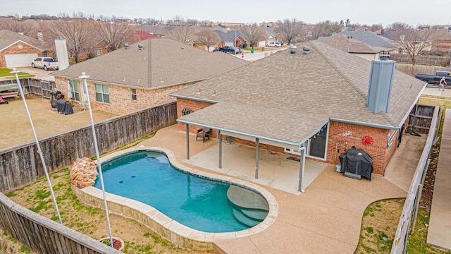 view of pool with a patio area, a residential view, a grill, and a fenced backyard