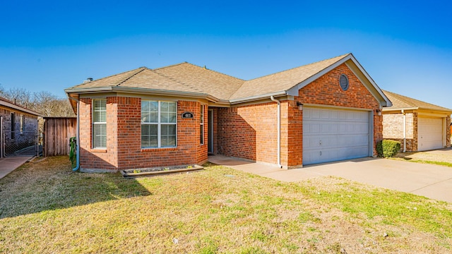 single story home with brick siding, a front lawn, fence, concrete driveway, and an attached garage