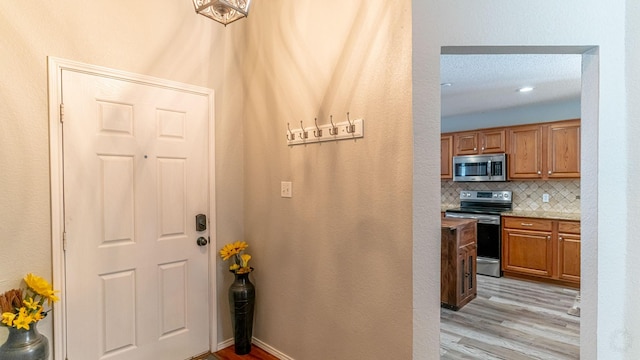 interior space featuring light wood-style flooring and baseboards