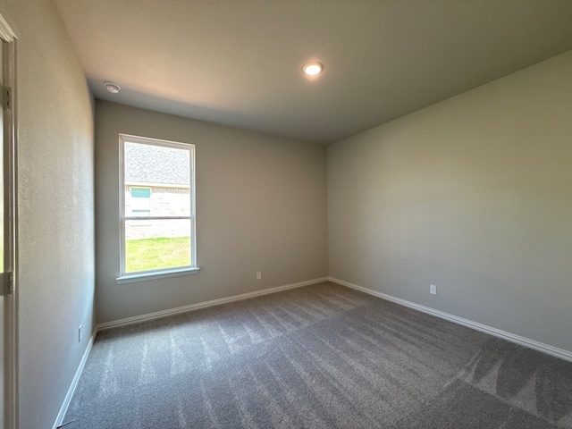 1412 Cedar Trl, Azle, TX 76020 - empty room featuring dark carpet, baseboards, and recessed lighting