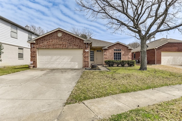 ranch-style home featuring a front yard, brick siding, concrete driveway, and an attached garage