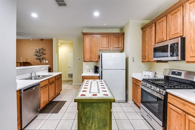 kitchen featuring visible vents, appliances with stainless steel finishes, a kitchen island, and light countertops