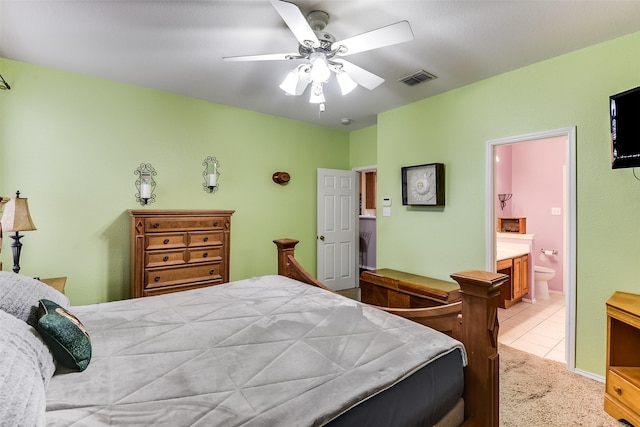 bedroom with visible vents, ensuite bathroom, and ceiling fan