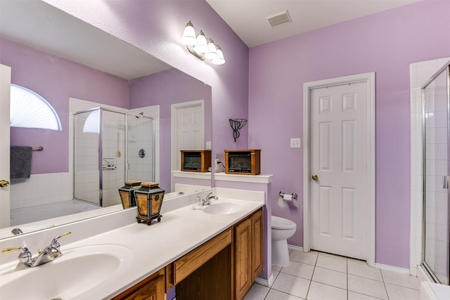 bathroom featuring tile patterned flooring, a shower stall, visible vents, and a sink