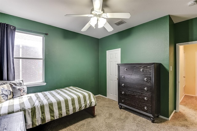 carpeted bedroom featuring a ceiling fan, baseboards, and visible vents