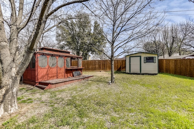 view of yard with an outbuilding, a storage shed, and a fenced backyard