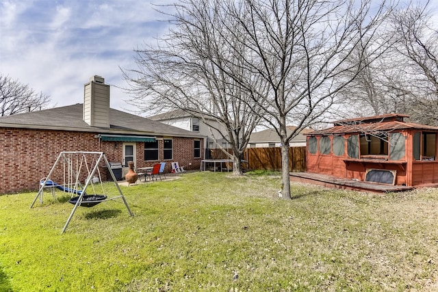 view of yard featuring a patio area, a trampoline, and fence