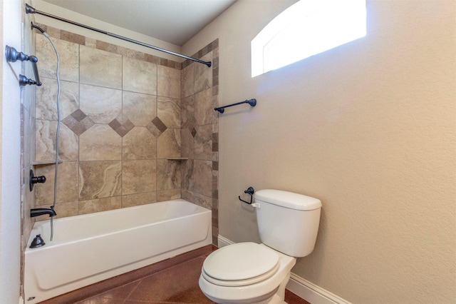 full bath with tile patterned flooring, toilet, shower / bathing tub combination, and baseboards