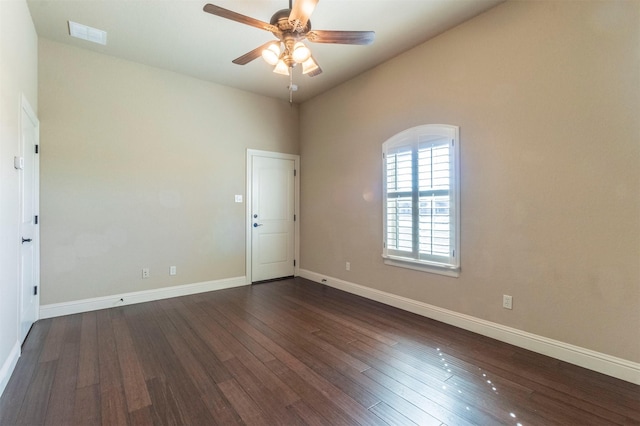 unfurnished room featuring a ceiling fan, visible vents, baseboards, and dark wood-style flooring