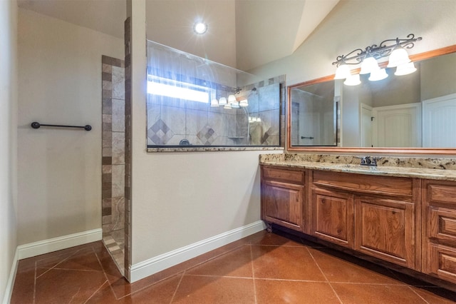 bathroom with baseboards, a walk in shower, vanity, and tile patterned flooring