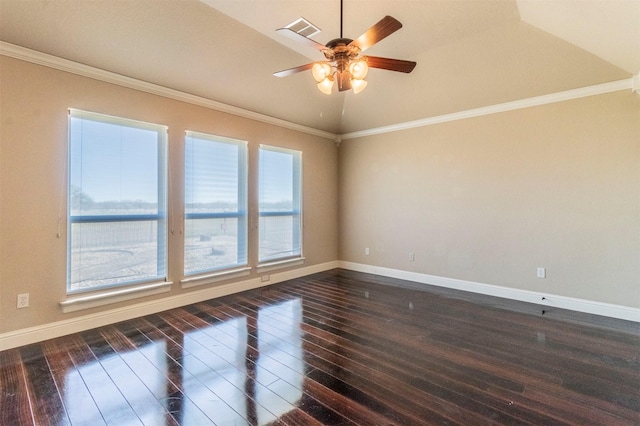 spare room featuring dark wood finished floors, crown molding, and baseboards