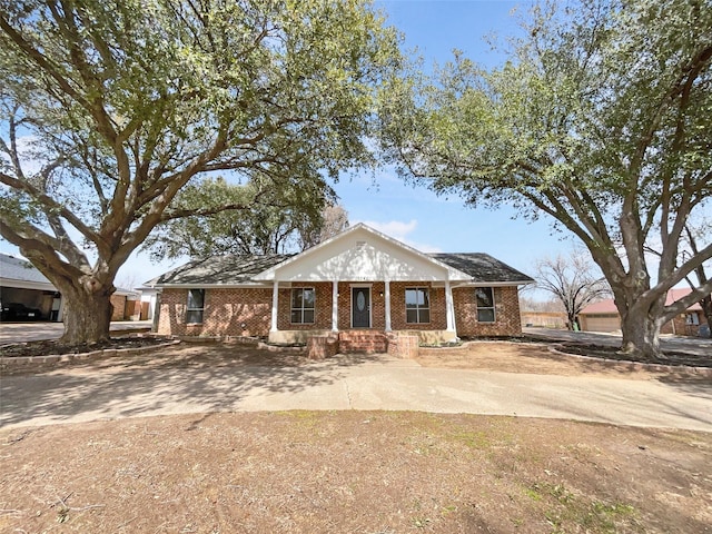 neoclassical / greek revival house with brick siding and concrete driveway