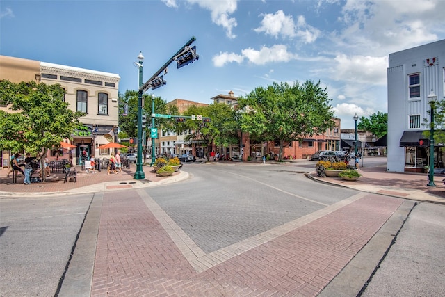 view of road featuring curbs, street lighting, and sidewalks