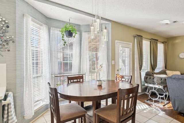 dining room with light tile patterned floors and a textured ceiling