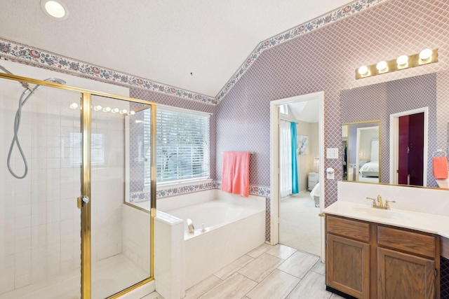 ensuite bathroom with wallpapered walls, a stall shower, and ensuite bathroom