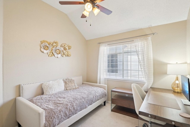 carpeted bedroom with vaulted ceiling and ceiling fan