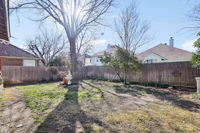 view of yard with a fenced backyard