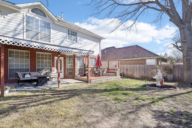 back of house with a patio, fence, a lawn, brick siding, and an outdoor hangout area