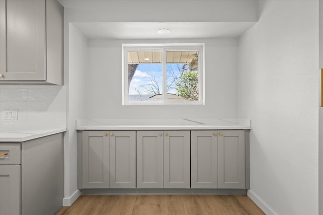 interior space featuring light countertops, gray cabinets, and light wood finished floors