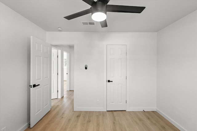 unfurnished bedroom featuring visible vents, baseboards, and light wood finished floors