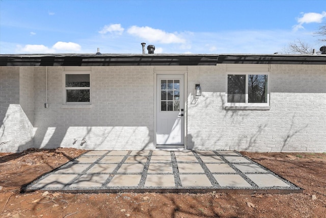 back of property featuring a patio and stucco siding