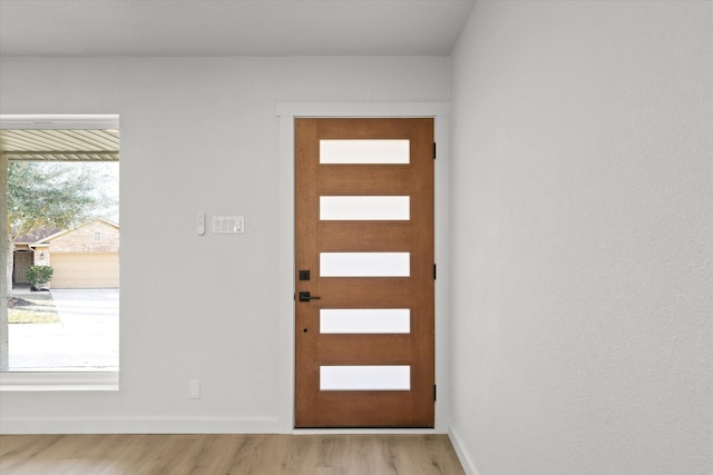 entrance foyer featuring baseboards and light wood-type flooring