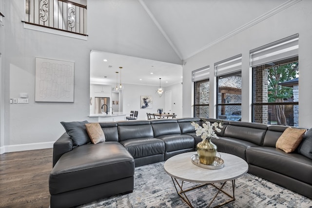 living room featuring crown molding, baseboards, dark wood finished floors, recessed lighting, and high vaulted ceiling