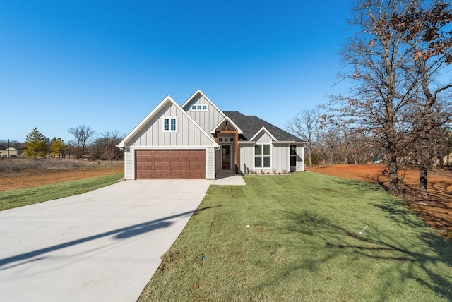 modern farmhouse style home featuring a front yard, concrete driveway, and board and batten siding