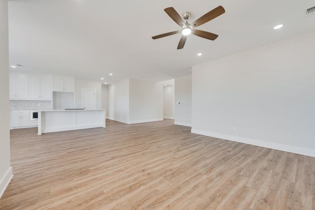 unfurnished living room featuring visible vents, baseboards, light wood-style flooring, recessed lighting, and ceiling fan