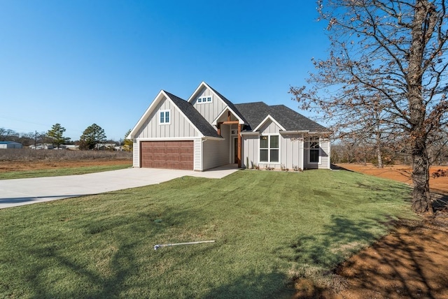 modern farmhouse featuring board and batten siding, concrete driveway, a front yard, a shingled roof, and a garage