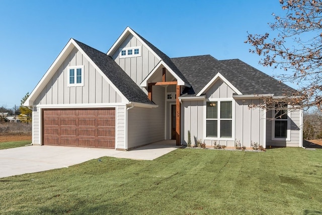 modern farmhouse with a front yard, board and batten siding, driveway, and roof with shingles