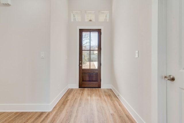 foyer entrance featuring baseboards and light wood-type flooring