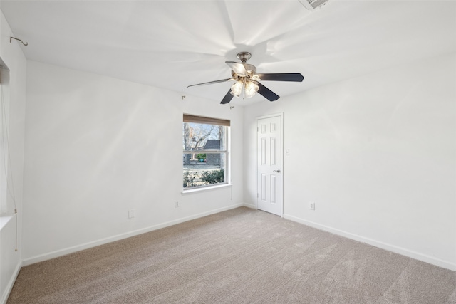 unfurnished room with a ceiling fan, light colored carpet, and baseboards