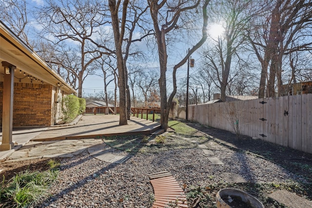 view of yard featuring a wooden deck and a fenced backyard