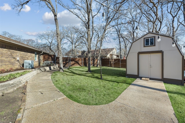 view of yard with an outdoor structure, central air condition unit, a storage unit, and a fenced backyard