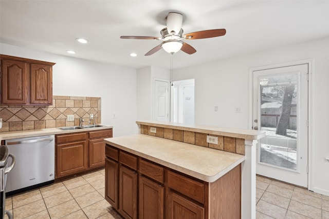 kitchen featuring light countertops, light tile patterned floors, decorative backsplash, stainless steel dishwasher, and a sink