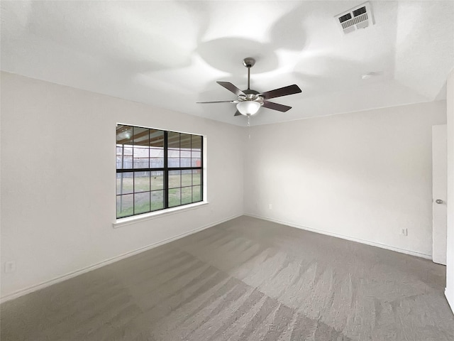 empty room with a ceiling fan, carpet flooring, baseboards, and visible vents