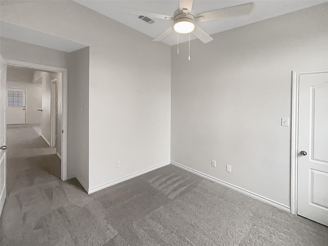 empty room featuring visible vents, baseboards, and ceiling fan