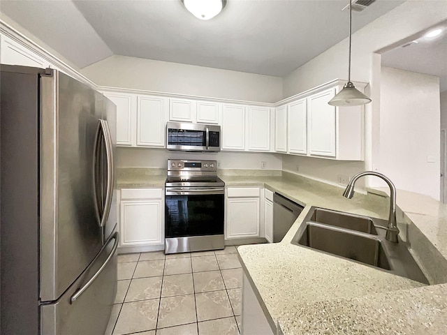 kitchen with light tile patterned flooring, white cabinets, appliances with stainless steel finishes, and a sink